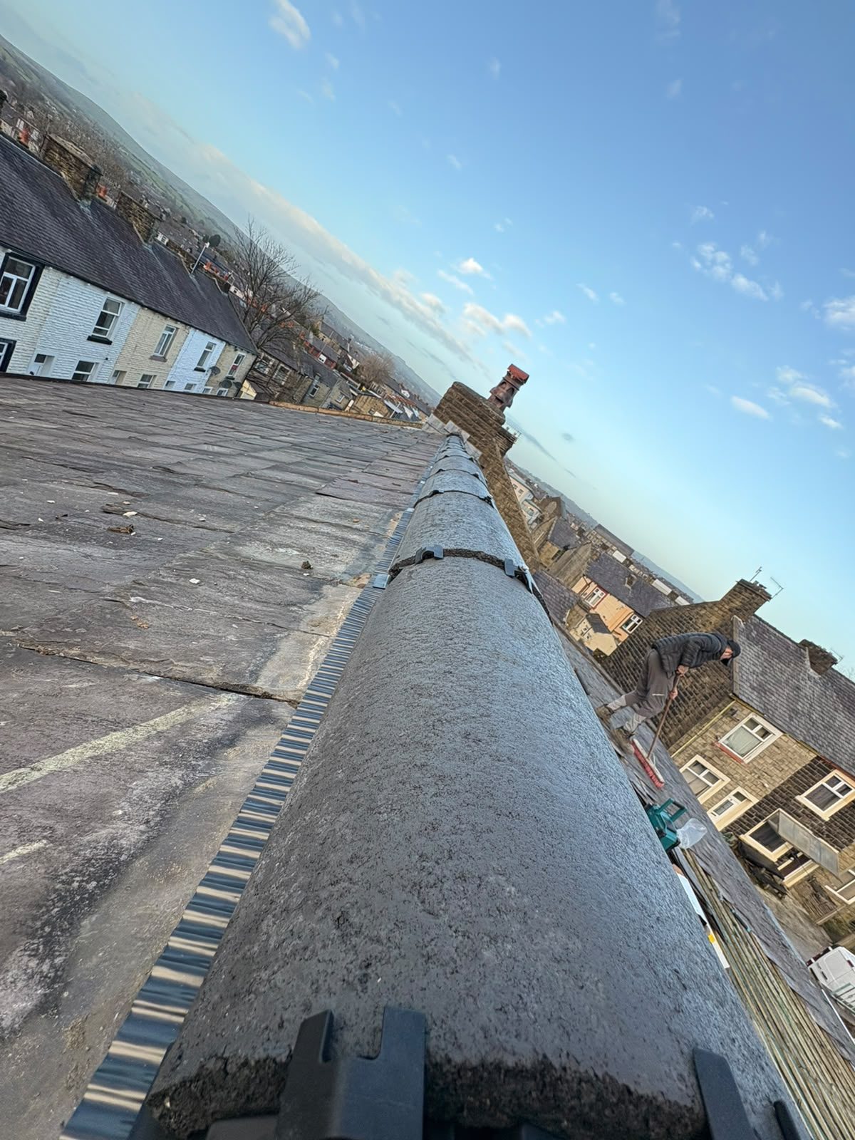 Dry ridge system fitted along the ridge line of a stone terrace roof during repointing work