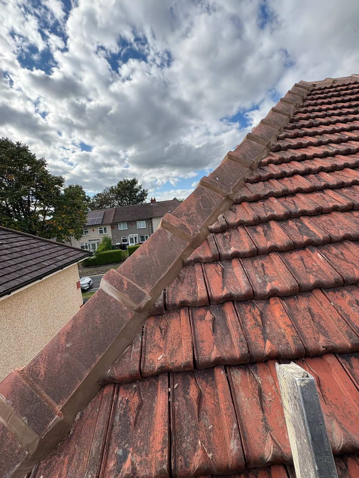 Freshly repointed verge and ridge line on a clay pantile roof